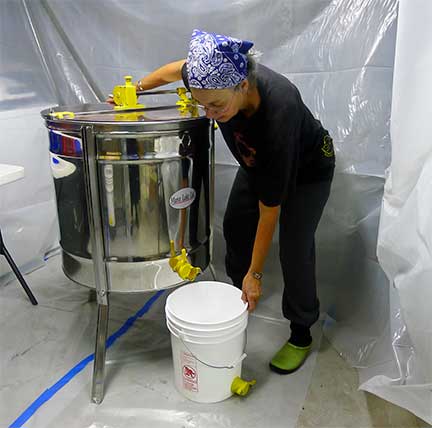 Beverly Barker Getting Ready to Drain Honey from Extractor